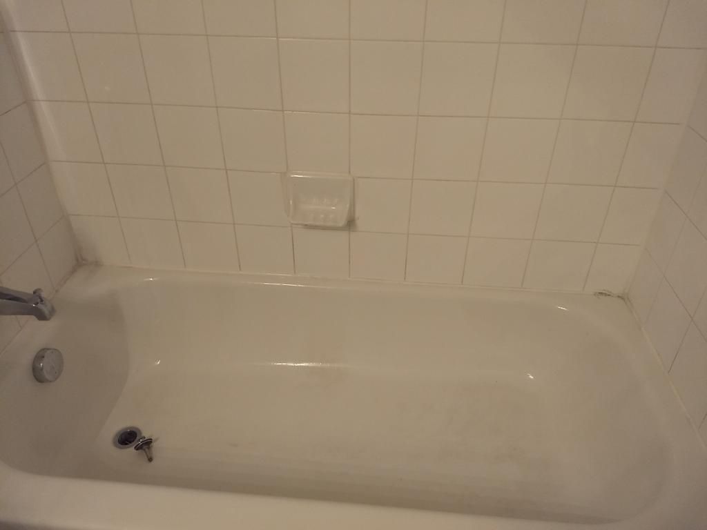 Bright bathtub and tile surround after cleaning